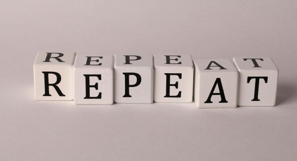 The image shows the word "repeat"
