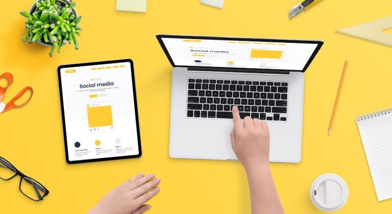 Social Media Ads vs. Google Ads Which one should you use. The image shows a laptop on a yellow desk.